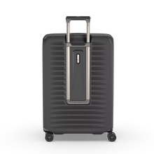 Load image into Gallery viewer, Back panel view of the hard shell suitcase with the telescopic handle partly extended. 
