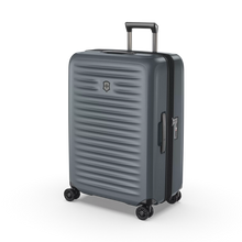 Load image into Gallery viewer, Angled front view of the hard shell suitcase. The telescopic handle is partly extended. 
