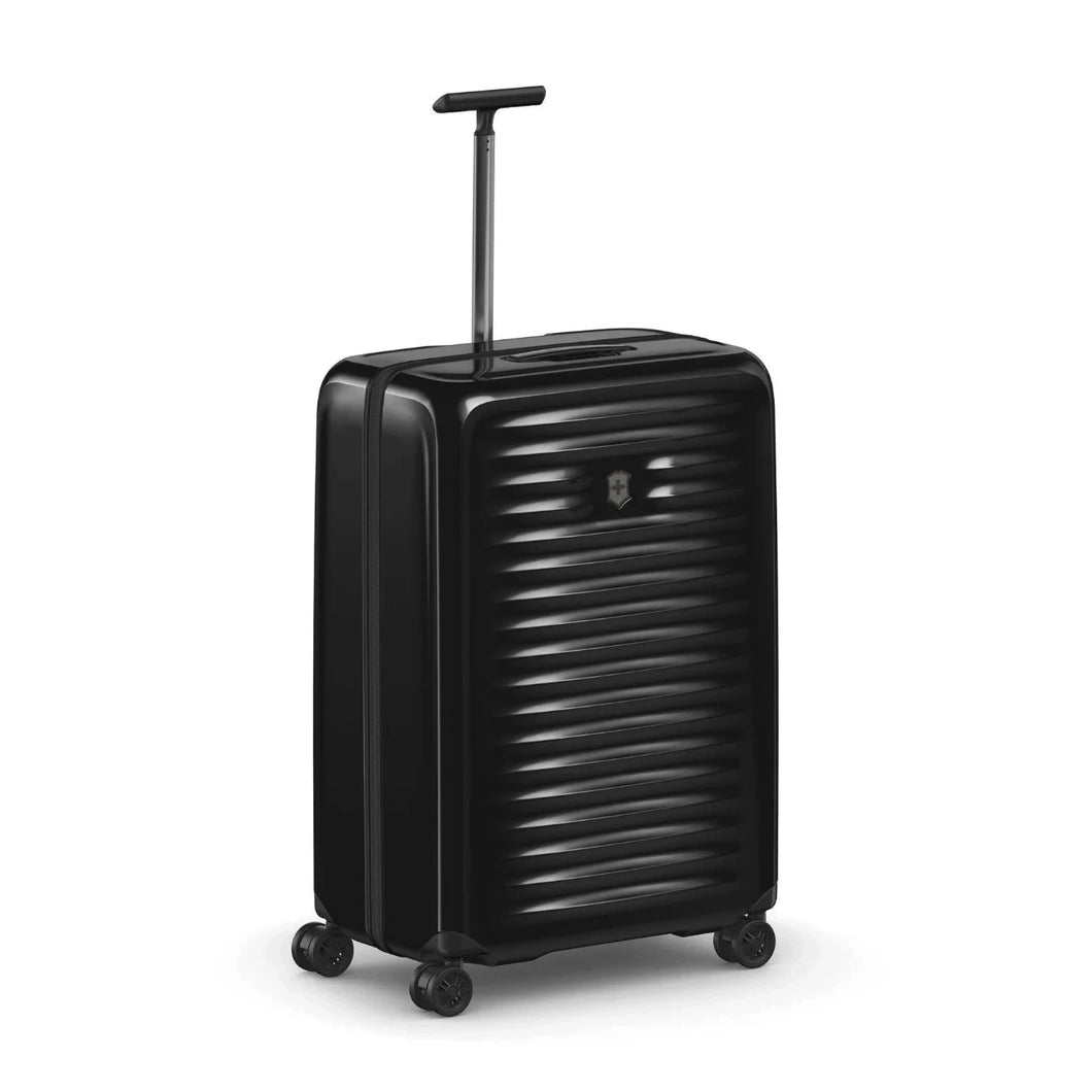 Angled front view of the black hard side case with the telescopic handle partly extended. 