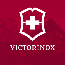 Load image into Gallery viewer, Victorinox logo on a red background with mountains. 
