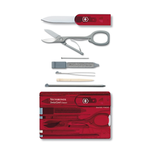 Load image into Gallery viewer, The tools of the Swiss card arranged next to the card case. 
