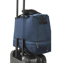 Load image into Gallery viewer, The duffle bag&#39;s back strap placed through a suitcase&#39;s telescopic handle to hold it in place. 
