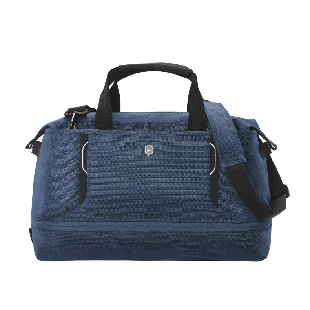 Front panel view of the blue duffle bag with the adjustable shoulder strap hanging on the right side. 