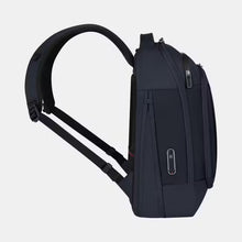 Load image into Gallery viewer, Side panel view of the navy blue backpack with the shoulder straps extended and the expandable feature unzipped..
