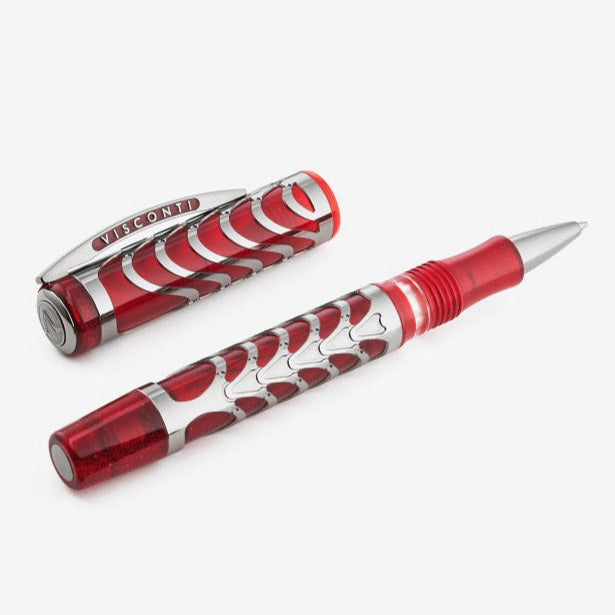 The Rollerball Pen laid on a white background with the cap set to the side.  The pen is made of translucent red resin with an overlay on top made of silver coated in palladium.