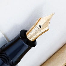 Load image into Gallery viewer, Close-up to the Visconti Black Urushi Fountain Pen Nib. Although it is not labeled, we believe it to be a FIne Nib. 
