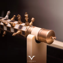 Load image into Gallery viewer, The Visconti Checkmate is featured on its pen rest with the chess pieces set on the body&#39;s board.
