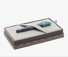 Load image into Gallery viewer, The The Visconti Homo Sapiens Earth Origins pen in the presentation box being held by the felt strap.
