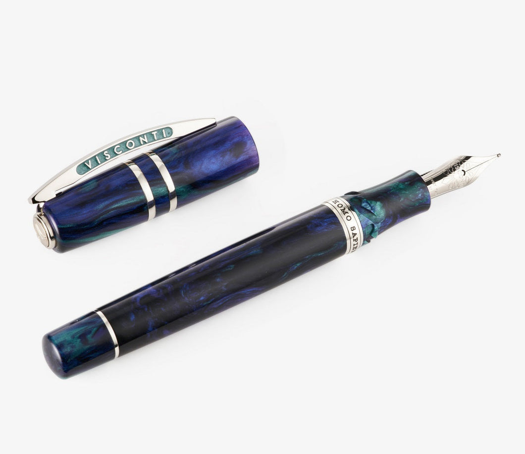 The Visconti Homo Sapiens Earth Origins Fountain Pen laid on a white background with the cap set to the side. 