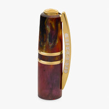 Load image into Gallery viewer, The cap of the rollerball pen with a marbled resin barrel in shades of red, orange, and brown, accented with a gold clip, shown on a light background.
