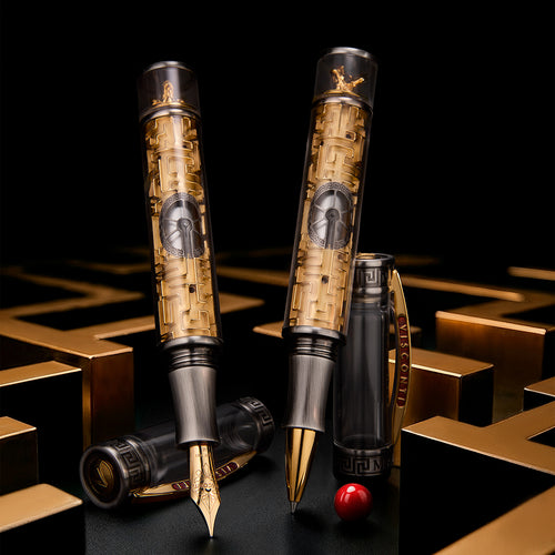 Two ornate pens with intricate maze designs on a black and gold background.
