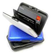 The black, blue, and white card cases stacked on top of each other. The white card case is opened and has two credit cards for visual purposes.