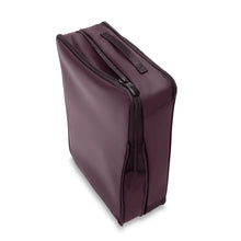 Load image into Gallery viewer, Angled view of the purple packing cube. It features a grip handle. The expandable feature is unzipped. 
