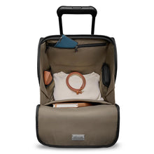 Load image into Gallery viewer, Top view of the opened underseat cabin spinner suitcase. A shirt, belt, travel accessories, and a book are organized in the compartments. 
