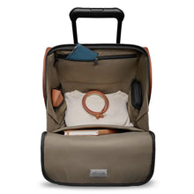 Load image into Gallery viewer, Top view of the cabin bag with t he main compartment opened. A passport holder, folded shirt, belt, book, and travel accessories are organized in the pockets.
