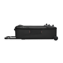 Load image into Gallery viewer, Side panel view of the black wheeled duffle with the front portion collapsed into itself. 
