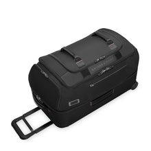 Load image into Gallery viewer, Angled view of the black duffle bag, laying on the back panel. 
