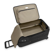 Load image into Gallery viewer, Angled view of the black wheeled duffle with the main compartment unzipped. It features tan fabric interior lining, a zipper-closing pocket, and a panel divider to organize contents.

