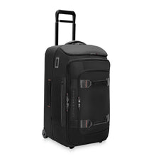 Load image into Gallery viewer, Angled front view of the black wheeled duffle standing vertically. The telescopic handle is pulled up.
