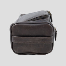 Load image into Gallery viewer, side view of a dark brown leather toiletry bag with a horizontal strap detail
