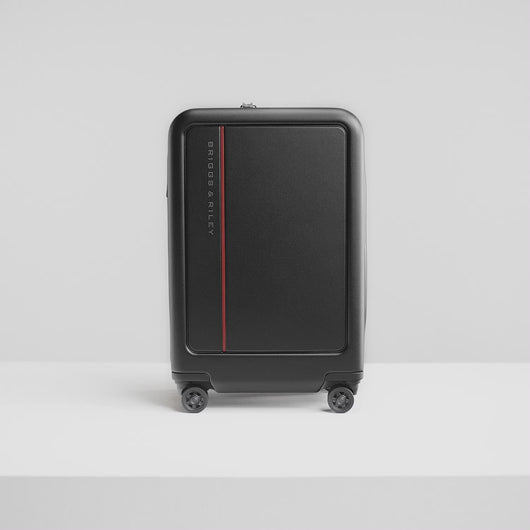 Angled views from the suitcase, followed by a young woman packing her belongings into it with the organization features. 