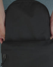 Load and play video in Gallery viewer, Different close ups of the Black Classic Herschel Backpack being opened to show clothes, a laptop, a calculator, and a water bottle on the side panel compartment.
