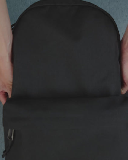 Different close ups of the Black Classic Herschel Backpack being opened to show clothes, a laptop, a calculator, and a water bottle on the side panel compartment.