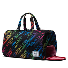 Load image into Gallery viewer, Angled view of the Stencil Rollcall Novel Duffle bag. The side panel shoe compartment is unzipped. 
