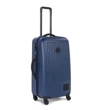 Load image into Gallery viewer, Angled front view of the navy blue Trade spinner suitcase.
