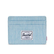 Load image into Gallery viewer, Front view of the Light Denim Charlie card case. A small white Herschel logo tag is sown at the center.
