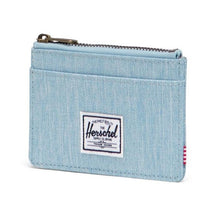 Load image into Gallery viewer, Angled view of the light denim Herschel  RFID Oscar Wallet with a zippered main compartment and external card slots.
