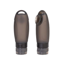 Load image into Gallery viewer, Front view and angled view of two black travel bottles on a white background. 
