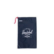 Load image into Gallery viewer, Front view of the navy shoe bag with red pull string. A white Herschel logo print is at the center.
