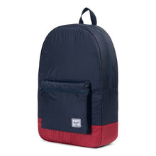Load image into Gallery viewer, Angled view of the Navy blue and red packable daypack. 
