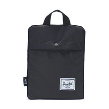 Load image into Gallery viewer, Front view of the Packable Daypack black backpack, folded into its pocket. 
