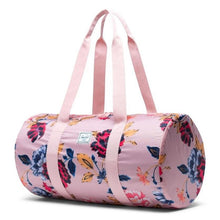 Load image into Gallery viewer, Angled front view of the Winter Flora bag with the pink shoulder straps pulled up.
