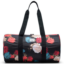 Load image into Gallery viewer, Front view of the Vintage Floral duffle bag with the shoulder straps pulled up.
