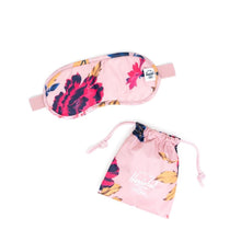 Load image into Gallery viewer, The Winter Flora eye mask arranged with the included bag on a white background.
