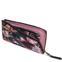 Load image into Gallery viewer, Angled view of the Jack wallet in Pixel Floral. The main compartment is unzipped. 
