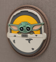 Load image into Gallery viewer, Close up to the rubber design with Grogu in his carrier on the front panel. 

