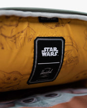 Load image into Gallery viewer, Interior close up to the front panel's pocket with Grogu pattern prints and a black Star Wars and Herschel logo tag. sown at the center.
