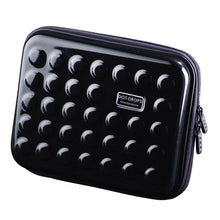 Load image into Gallery viewer, Angled front view of a black hard-shell case with a pattern of raised dots on the front and back panels. 

