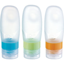 Load image into Gallery viewer, Front view of the transparent travel bottles with blue, green, and orange cap rings. 

