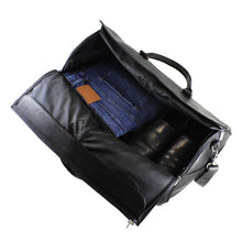Load image into Gallery viewer, Angled top view of the black leather garment duffle bag. A pair of folded jeans and black shoes are organized inside.

