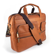 Load image into Gallery viewer, Angled front view of the tan leather briefcase. with the removable shoulder strap resting across the front.
