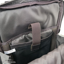 Load image into Gallery viewer, Interior close up to the brown leather backpack's laptop and tablet compartments. 
