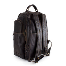 Load image into Gallery viewer, Angled back view of the brown leather backpack. 
