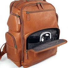 Load image into Gallery viewer, Close up to the tan leather backpack's front panel. The bottom pocket is opened, and a cellphone, USB cable, and pens are arranged in the organization compartments.
