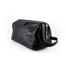 Load image into Gallery viewer, Angled view of the black leather toiletry bag. 
