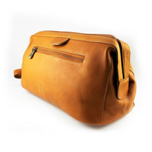 Load image into Gallery viewer, Angled view of the tan leather toiletry bag. 
